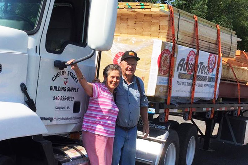 Owners, Elwood and Harlean Smoot, standing near company truck
